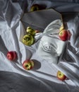 Marble copy eye of david reflected in a mirror in a frame against a background of white drapery fabric with folds with fruits Royalty Free Stock Photo