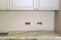 marble countertop with cutout for sink or hob in modern classic kitchen. Wall sockets with exposed electrical wires removed before Royalty Free Stock Photo