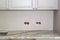 marble countertop with cutout for sink or hob in modern classic kitchen. Wall sockets with exposed electrical wires removed before Royalty Free Stock Photo