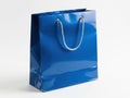 Glossy Blue Paper Shopping Bag with Rope Handles Isolated on White Background Royalty Free Stock Photo