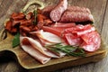 Marble cutting board with prosciutto, bacon, salami and sausages