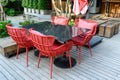 Marble dining table with red weave chairs with pillow on patio
