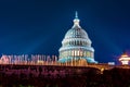 Marble dome of the United States Capitol building illuminated by rays of architectural light on a clear blue night with fountain Royalty Free Stock Photo