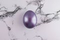 Marble Easter flat lay background with painted Easter egg