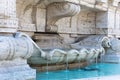 Marble fountain with blue water in Rome, Italy