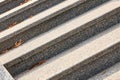 Marble, granite steps of gray color, parallel lines are located diagonally