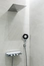 Marble gray wall, rain shower and shower head. Modern bathroom design