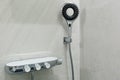 Marble gray wall and shower head. Modern bathroom design