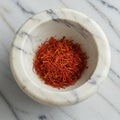 Marble mortar containing a heap of saffron threads (Crocus sativus). The mortar is Royalty Free Stock Photo