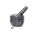 Marble mortar with pestle and black pepper peas Royalty Free Stock Photo