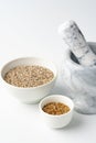 Marble mortar and pestle with spices on white background Royalty Free Stock Photo