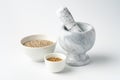 Marble mortar and pestle with spices on white background Royalty Free Stock Photo