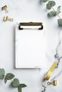 Marble office desk table with clipboard mockup golden supplies eucalyptus leaves.