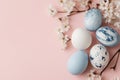 Marble-patterned Easter eggs arranged with dried flowers on a pastel pink background Royalty Free Stock Photo