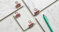 Marble-patterned surfaces are arranged with pink binder clips positioned on top. Royalty Free Stock Photo