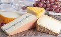 Marble plate with sheep milk cheeses Pur Brebis and Ossau-Iraty from Pyrenees, yellow Saint Paulin and Morbier cow milk cheeses, Royalty Free Stock Photo