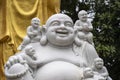 Marble sculpture of the happy Buddha with children in a Buddhist temple in the city of Danang, Vietnam