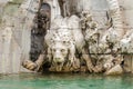 Marble sculpture of a lion statue in the fountain of four rivers in Piazza Navona in Rome, capital of Italy Royalty Free Stock Photo