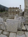 Carved marble slab and the Celsus library, Ephesus, Turkey Royalty Free Stock Photo