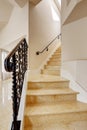 Marble staircase with black wrought iron railing