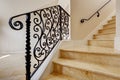 Marble staircase with black wrought iron railing Royalty Free Stock Photo