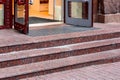 Marble staircase with granite steps to entrance door on store. Royalty Free Stock Photo