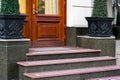 Marble staircase with granite steps to wooden entrance door. Royalty Free Stock Photo