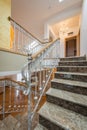 Marble stairs with wrought iron stair railings in luxury villa Royalty Free Stock Photo