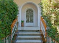 A marble stairway to arched portico house entrance classic design iron cast white door.