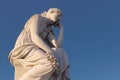 Marble statue of a female figure atop a cylindrical stone pillar