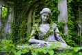 a marble statue nestled amongst ivy-covered ruins Royalty Free Stock Photo