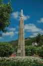 Statue of Our Lady over pillory in a flowered garden Royalty Free Stock Photo