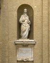 Marble statue of Saint Clare of Assisi on the right front of the Basilica of Saint Mary of the Angels in Assisi, italy.