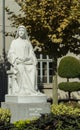 Marble statue of Saint Therese in park, Lourdes, France. Religious architecture details. Beautiful sculpture of catholic saint.