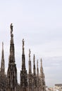 Marble statues on the stone spiers of the roof of the Milan Cathedral.