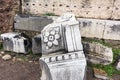Marble stone element of the ancient building with the image of a flower, the ruins of the Roman forum