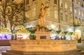 Marble stone monument to the goddess Amphitrite in the form of a fountain on the background of the Christmas Fair in the central M