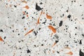 Marble surface with orange and black speckles
