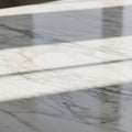 Marble surface with a white base, featuring delicate gray veining throughout. Shadows Royalty Free Stock Photo