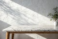 Marble table with white stucco wall and light beam Royalty Free Stock Photo