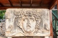 Marble tablet with ancient stone carving of Medusa Head. Royalty Free Stock Photo