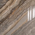 Marble texture featuring a mix of earthy tones, including gray, beige, and brown, with prominent veining and speckled patterns Royalty Free Stock Photo