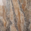 Marble texture featuring a mix of earthy tones, including gray, beige, and brown, with prominent veining and speckled patterns Royalty Free Stock Photo