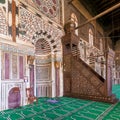 Marble wall with engraved Mihrab, and wooden Minbar, at Mamluk era Mosque of Sultan al Muayyad, Old Cairo, Egypt Royalty Free Stock Photo