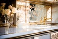 Marble washbasin with mother of pearl finish and gold tap