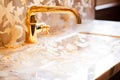 Marble washbasin with mother of pearl finish and gold tap