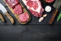 Marbled beef meat steak cut, tomahawk, t bone, club steak, rib eye and tenderloin cuts, on black wooden background, top view flat Royalty Free Stock Photo