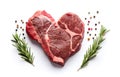 marbled beef steak like heart shape and rosemary hearb isolated on white background