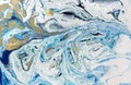 Marbled blue abstract background with golden sequins. Liquid marble ink pattern.