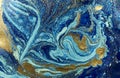 Marbled blue and golden abstract background. Liquid marble pattern